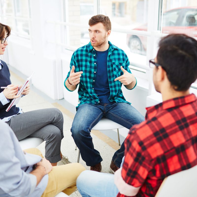 Therapist speaking to a rehab group at therapy session